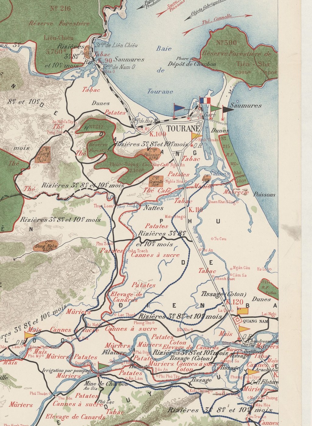 A section of a colour-printed map: the coast from the bay of Tourane (Đà Nẵng) down to the citadel of Quảng Nam, a river running the length of the coast joining the two ends, kilometre markers K.90 to K.120 along the colonial road, and crops such as tobacco, mulberry and sugar cane labelled in red.